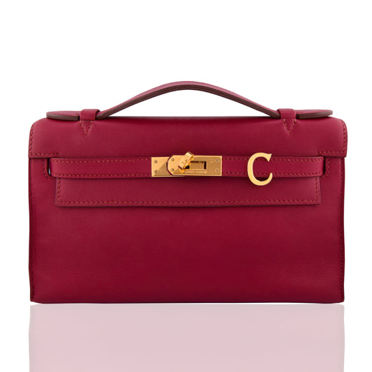 Red handbag with a gold clasp on a white background, collection-preview