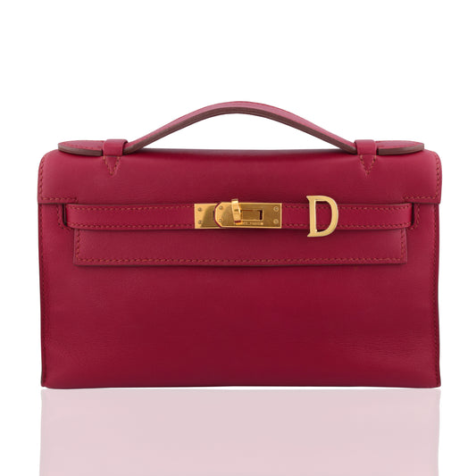 Red handbag with gold hardware on a white background, collection-preview