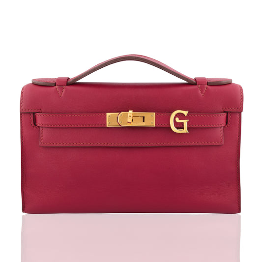 Red handbag with gold clasp on a white background, collection-preview