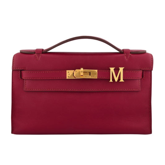 Red handbag with gold hardware on a white background, collection-preview