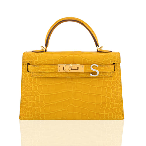 Yellow handbag with gold hardware on a white background, collection-preview