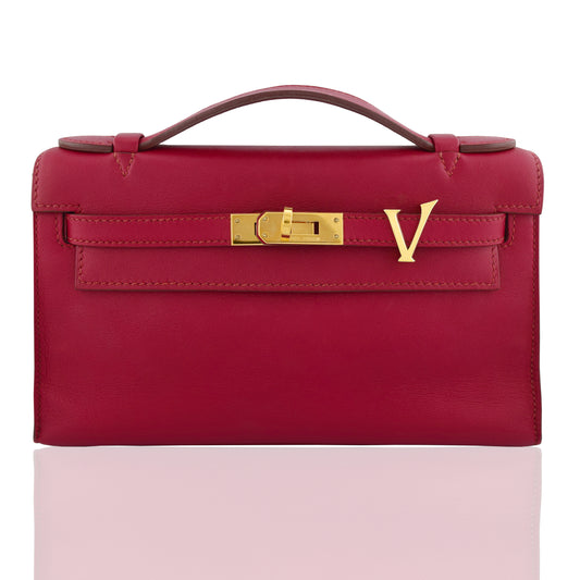 Red handbag with gold clasp on a white background, collection-preview