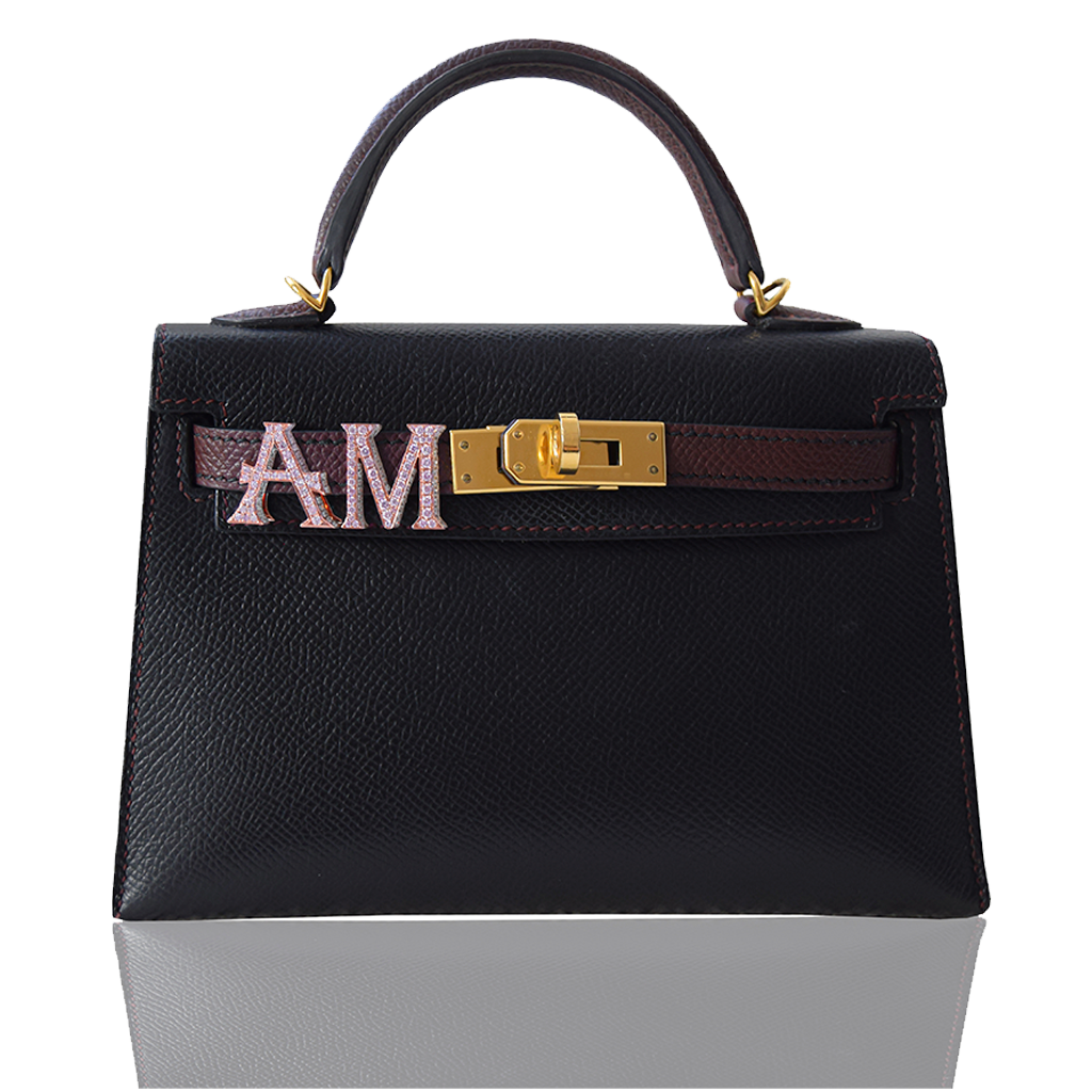 Black handbag with gold hardware and a decorative band on a white , collection-previewbackground