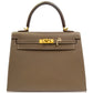 Brown handbag with gold hardware on a white background, collection-preview
