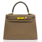 Brown handbag with gold hardware on a white background, collection-preview