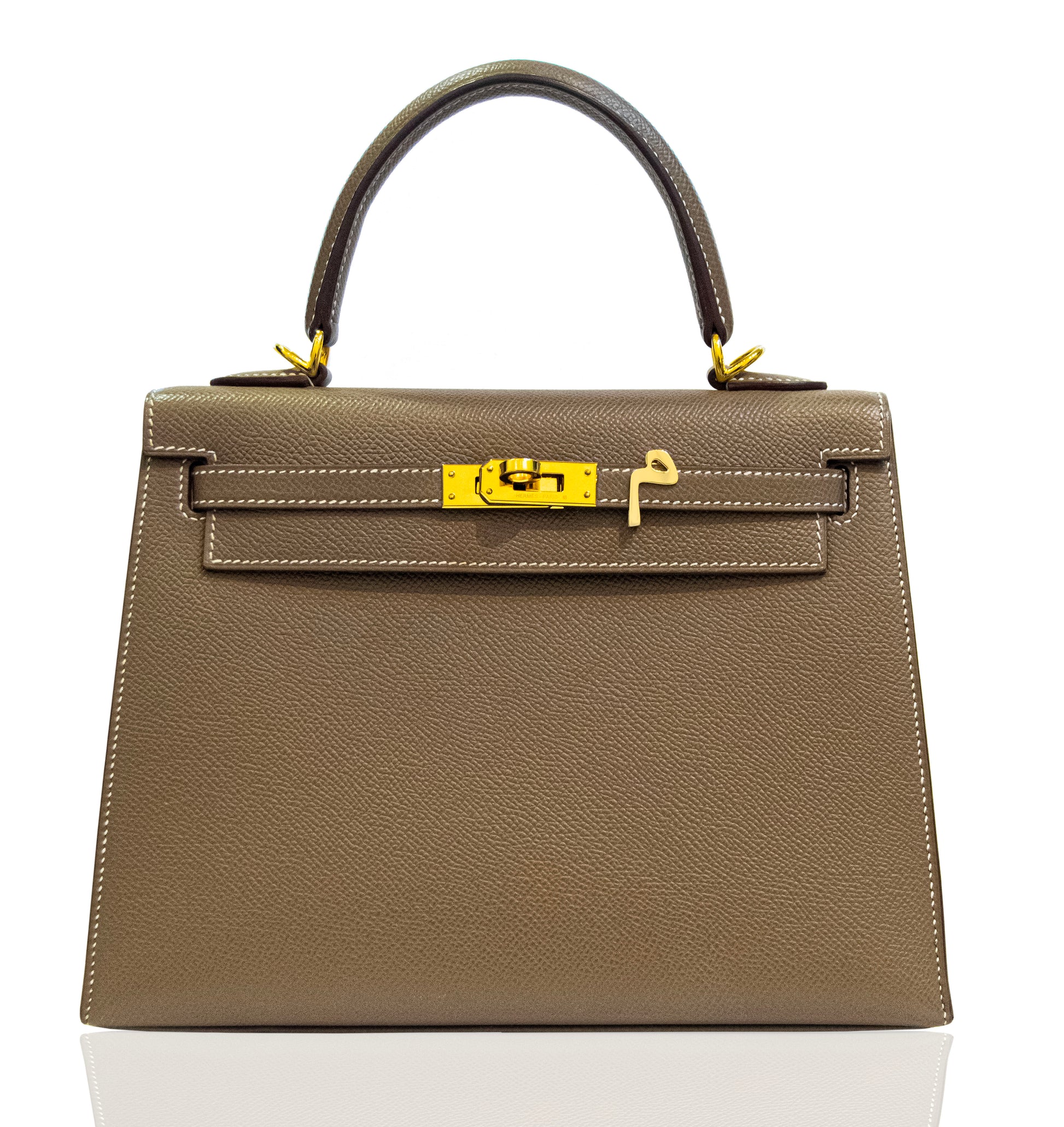 Brown handbag with gold hardware on a white background, collection-preview
