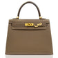 Brown handbag with gold hardware on a white background, collection-preview