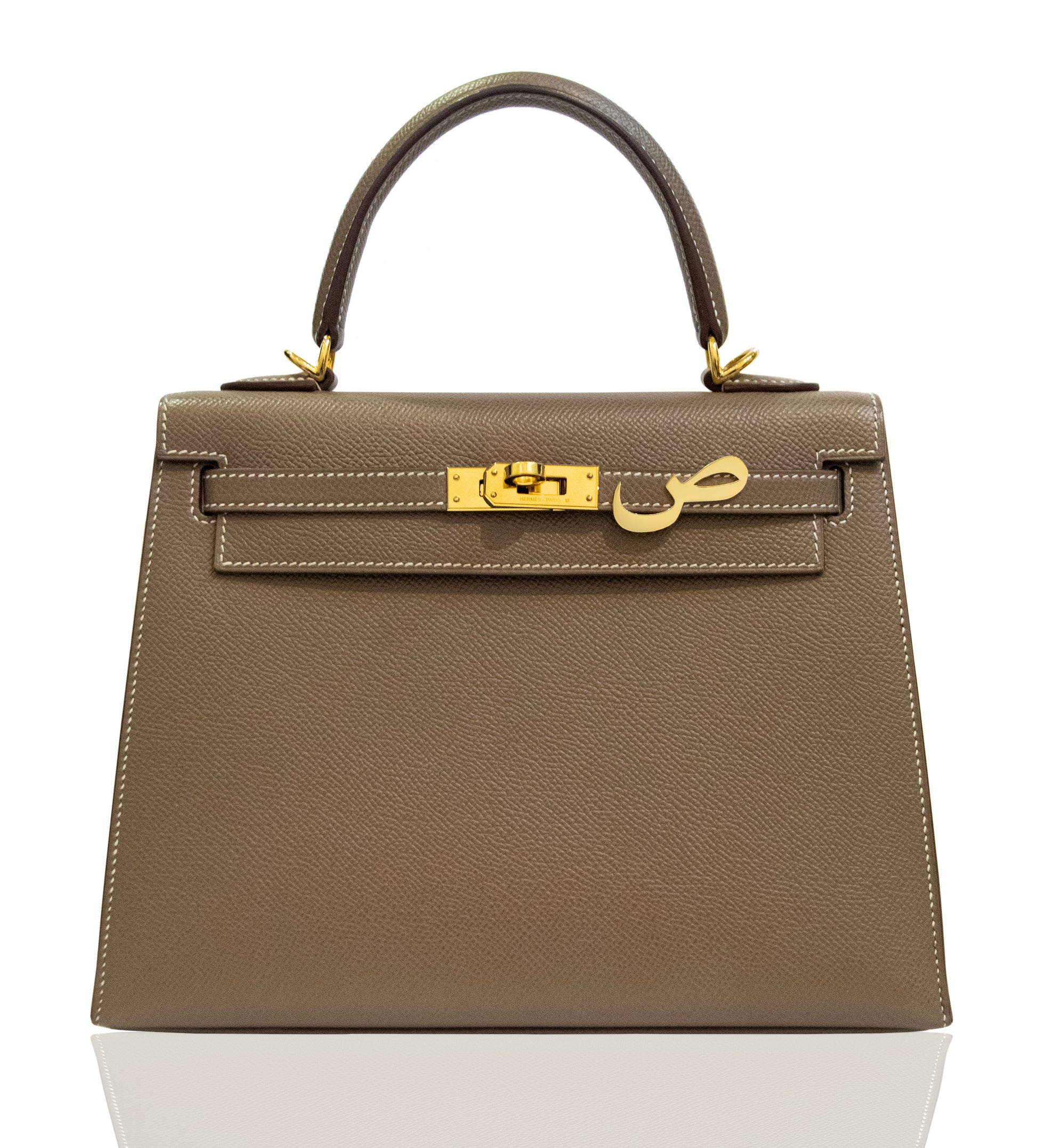 Brown handbag with gold hardware on a white background, collection-preview