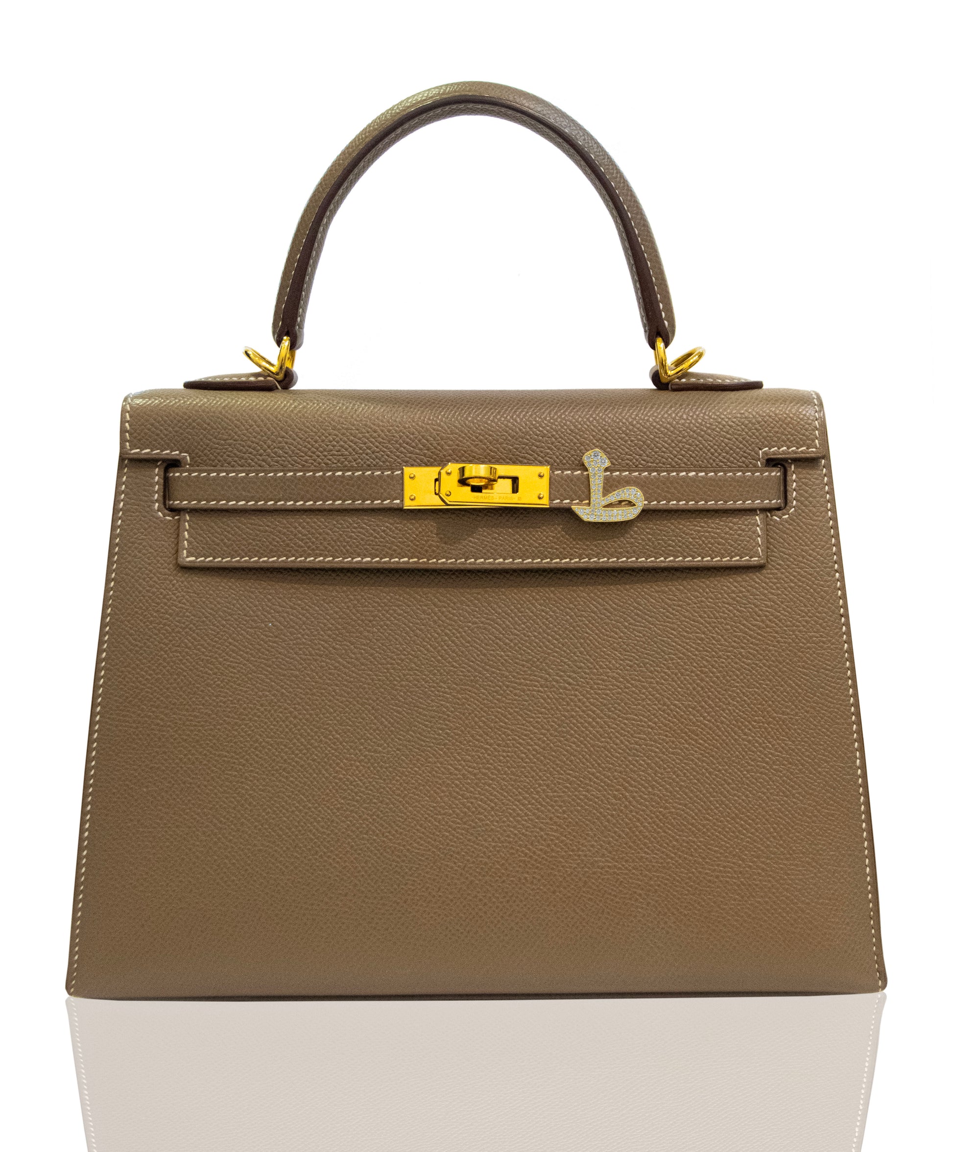 Brown handbag with gold hardware on a white background, collection-preview