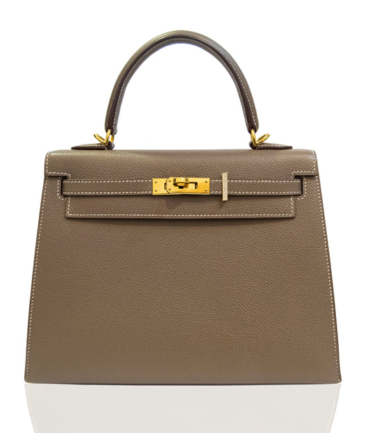 Brown handbag with gold hardware on a white background, collection-preview