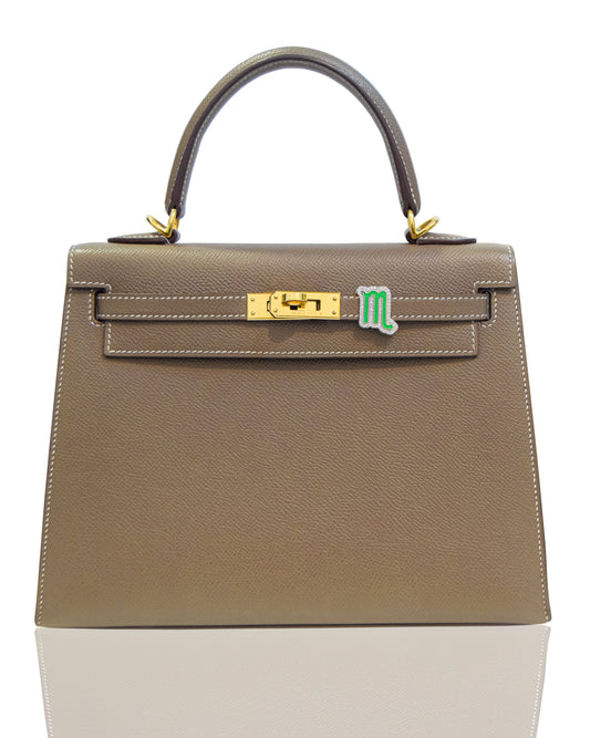 Brown handbag with gold hardware on a white background, collection-preview