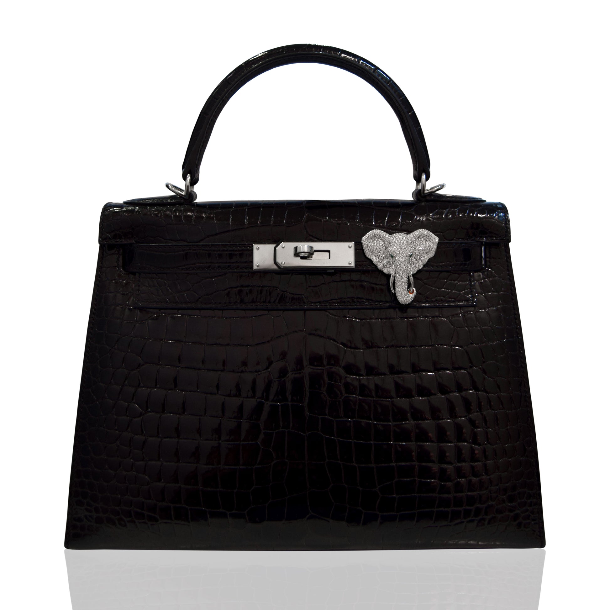 Black textured handbag with a silver clasp on a white background, collection-preview