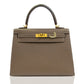 Brown handbag with gold hardware on a white background, collection-preview