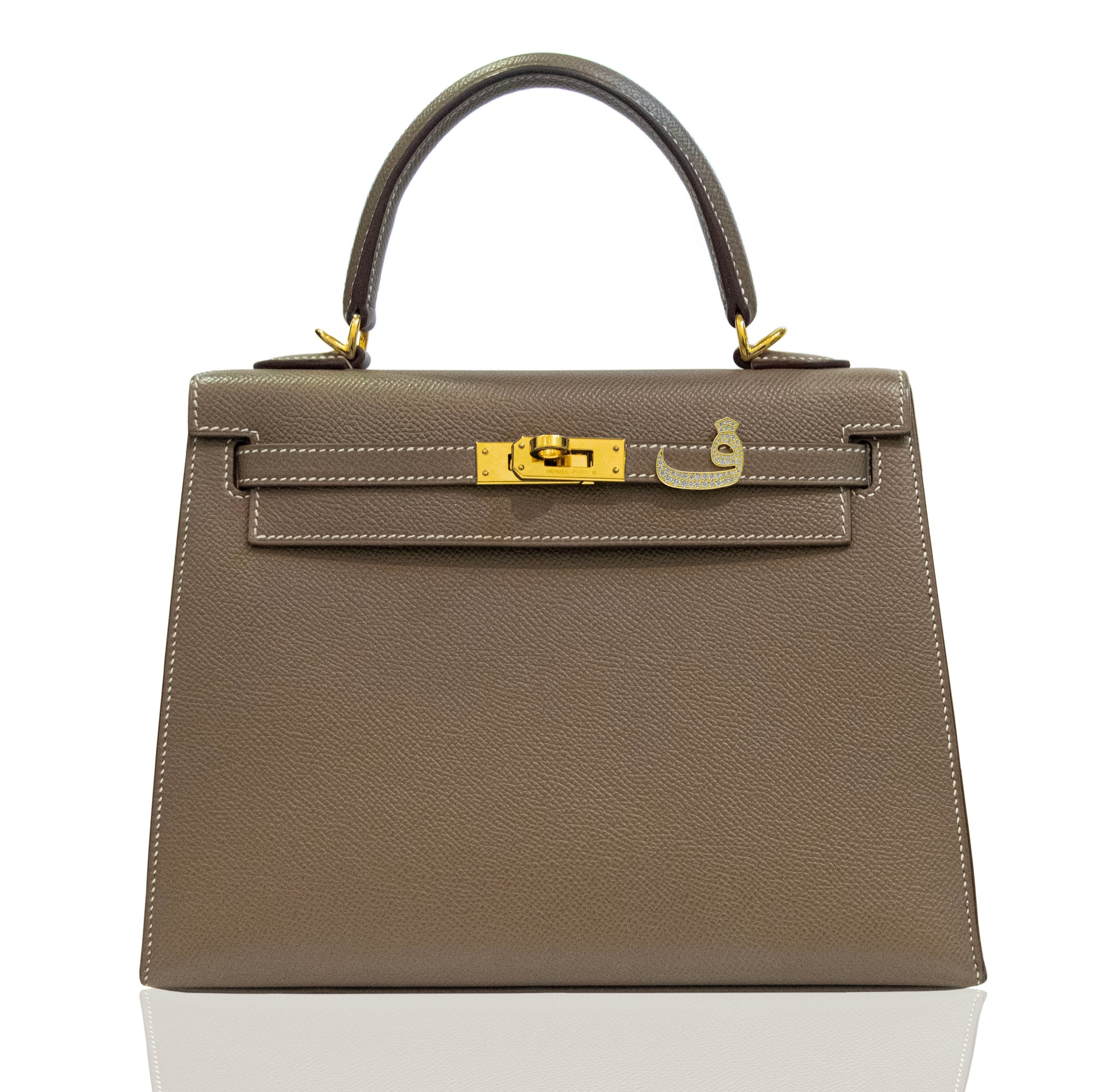 Brown handbag with gold hardware on a white background, collection-preview
