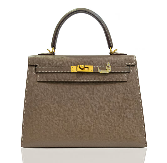 Brown handbag with gold hardware on a white background, collection-preview