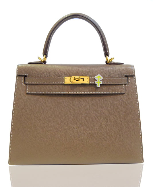 Brown handbag with gold clasp on a white background, collection-preview