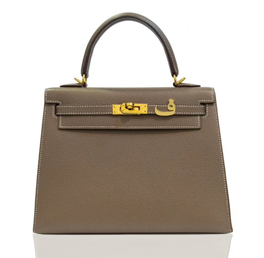 Brown handbag with gold hardware on a white background, collection-preview