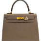 Gray handbag with gold hardware on a white background, collection-preview