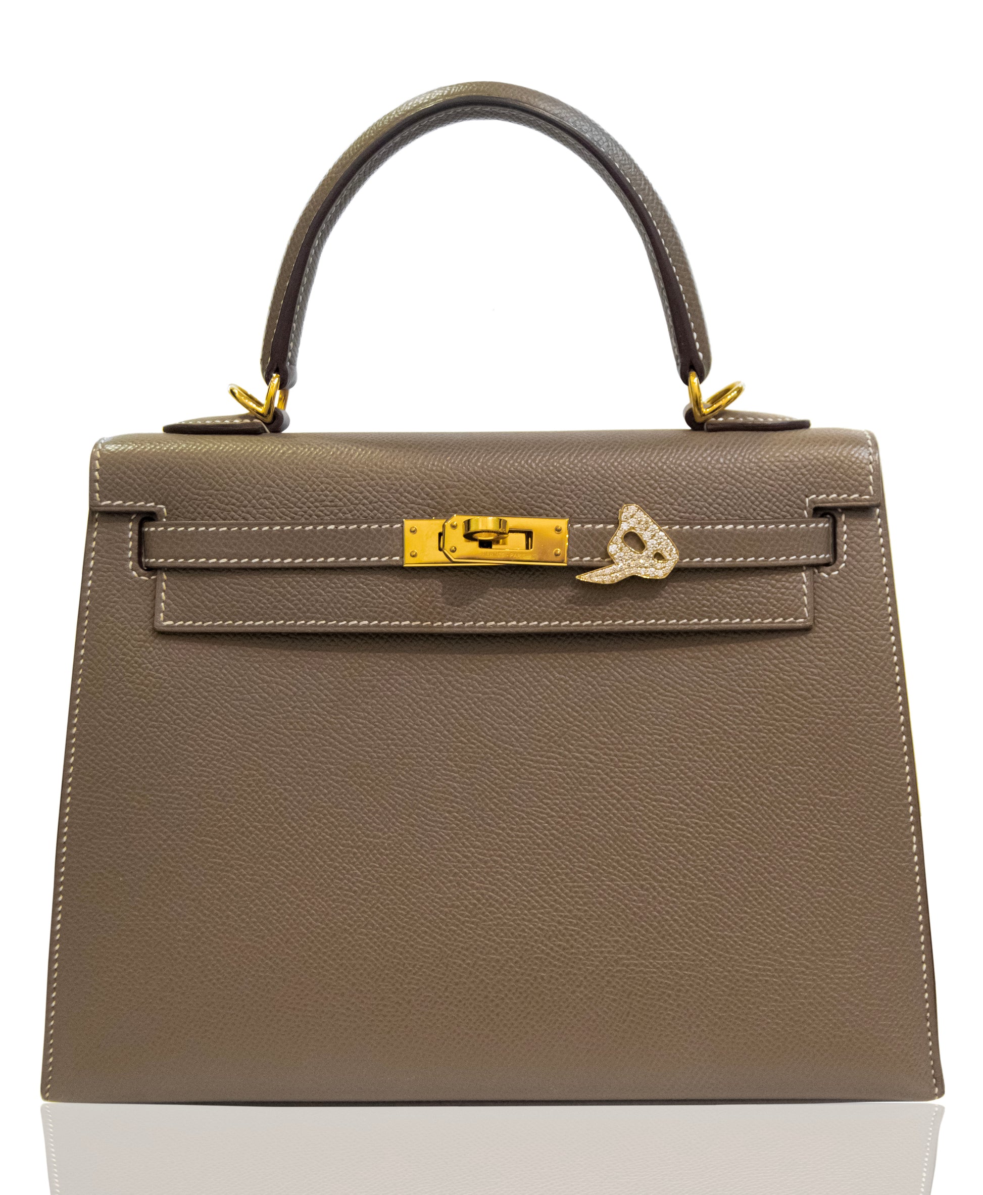 Gray handbag with gold hardware on a white background, collection-preview