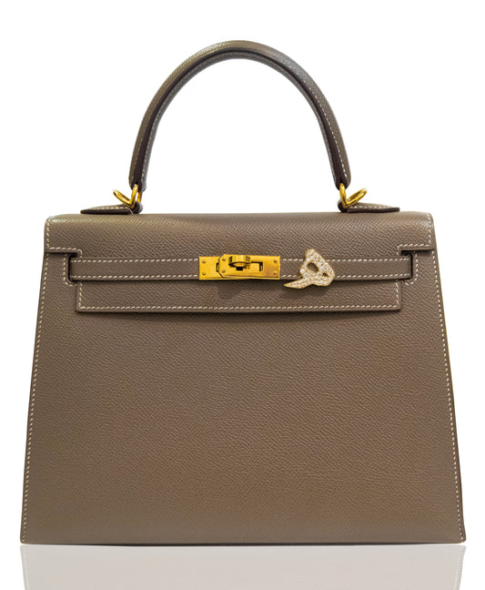 Gray handbag with gold hardware on a white background, collection-preview
