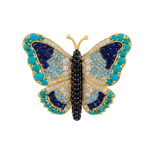 Butterfly-shaped jewelry with blue, black, and gold colors on a white background