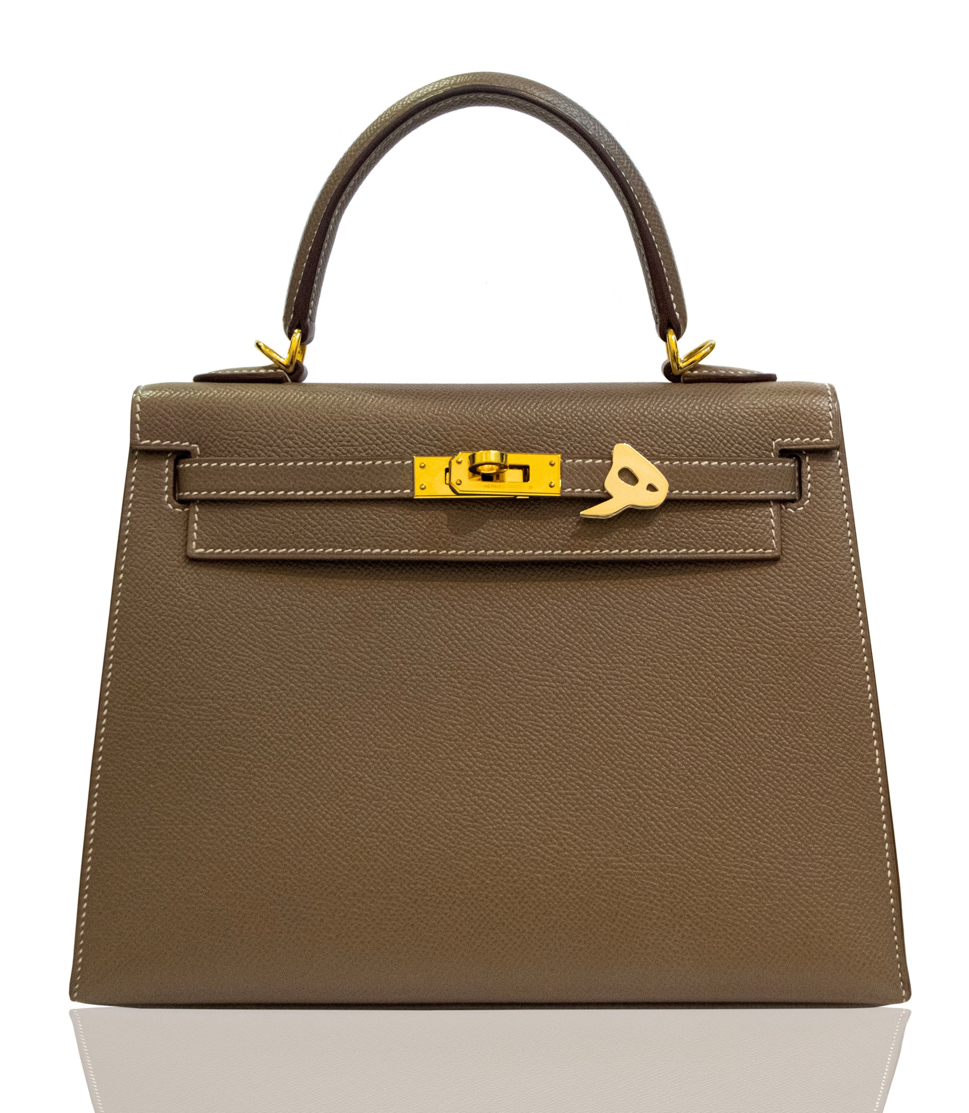 Brown handbag with gold hardware on a white background, collection-preview