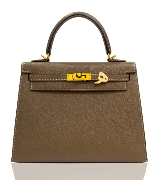 Brown handbag with gold hardware on a white background, collection-preview