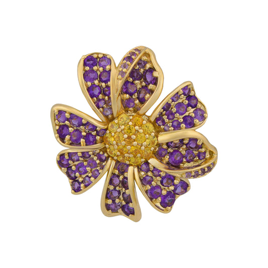 Gold flower-shaped brooch with purple gemstones on a white background