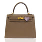 Brown handbag with a heart-shaped clasp on a white background, collection-preview