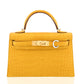 Yellow crocodile skin handbag with gold hardware on a white background, collection-preview