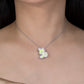 Necklace with a butterfly pendant worn by a model against a black background