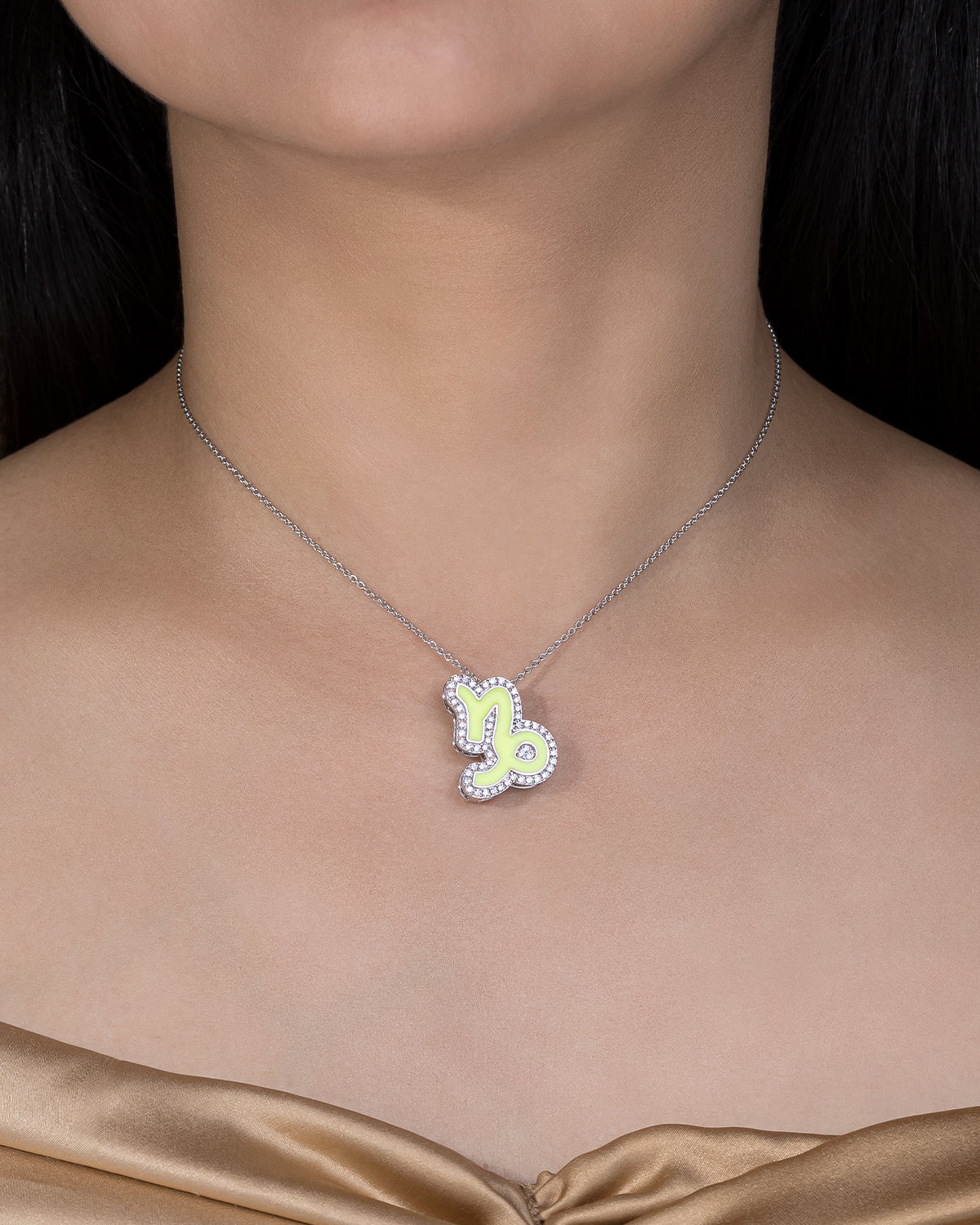 Necklace with a butterfly pendant worn by a model against a black background