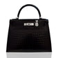 Black textured handbag with a silver clasp and cat charm on a white background, collection-preview