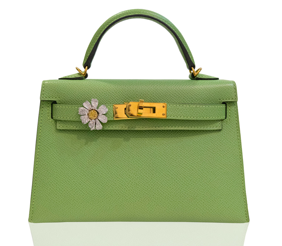 Green handbag with floral detail on a white background, collection-preview