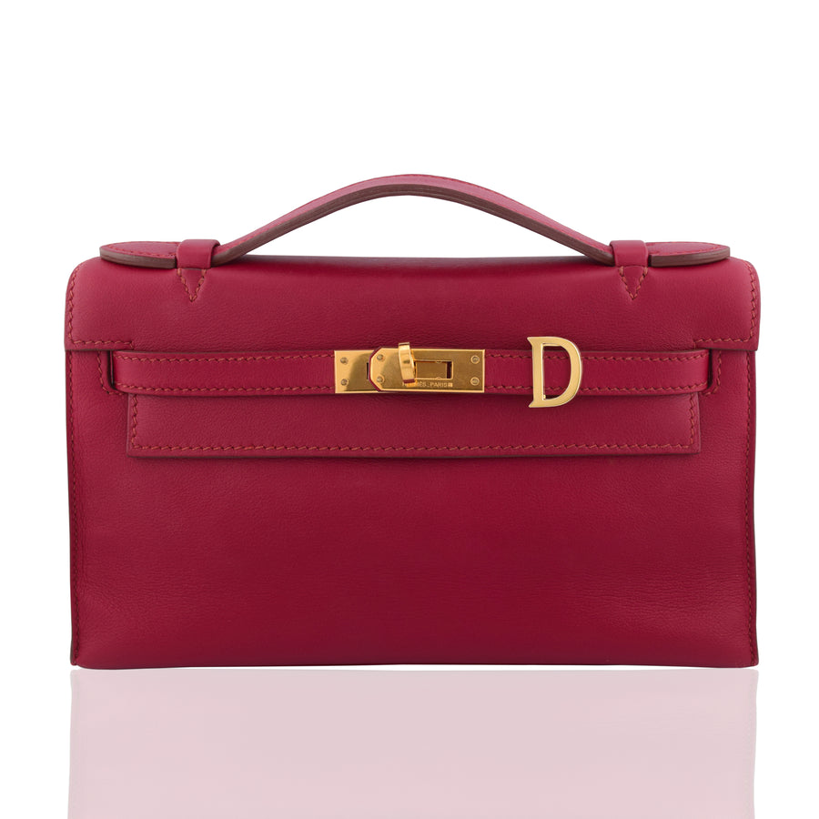 Red handbag with gold hardware on a white background, collection-preview