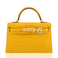 Yellow crocodile-patterned handbag with gold hardware on a white background, collection-preview