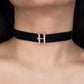 Navy blue choker with a silver 'H' pendant on a person's neck.