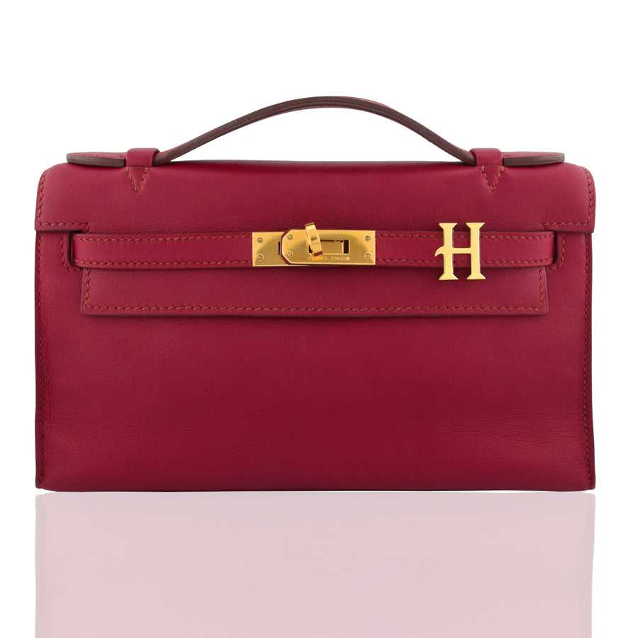 Red handbag with gold hardware on a white background, collection-preview