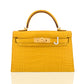 Yellow crocodile-patterned handbag with gold hardware on a white background, collection-preview