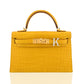 Yellow crocodile-patterned handbag with gold hardware and a silver 'K' on a white background, collection-preview