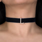 Black choker necklace with a silver clasp on a person's neck
