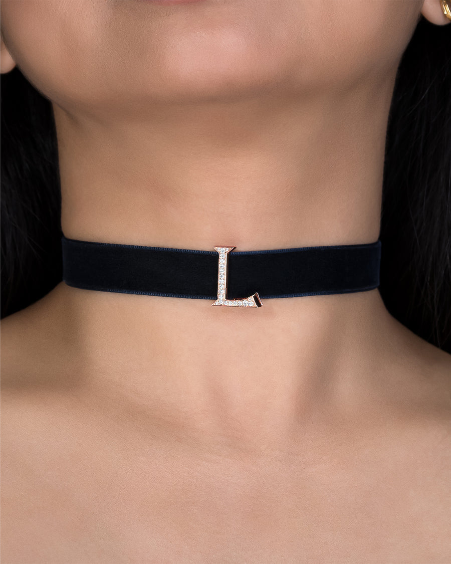 Black choker necklace with a silver clasp on a person's neck