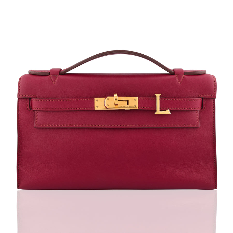 Red handbag with gold hardware on a white background, collection-preview