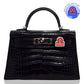 Black crocodile-patterned handbag with a distinctive clasp on a white background, collection-preview