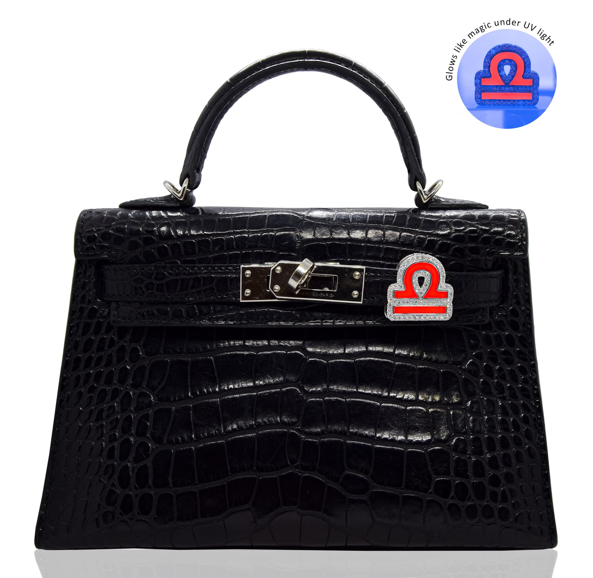 Black crocodile-patterned handbag with a distinctive clasp on a white background, collection-preview