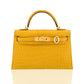 Yellow crocodile-patterned handbag with a gold buckle on a white background, collection-preview