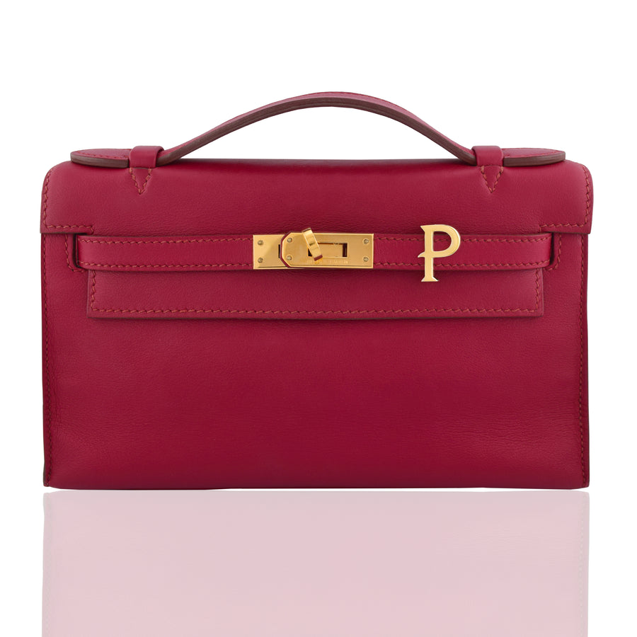 Red handbag with gold clasp on a white background, collection-preview