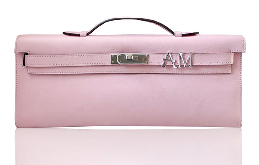 Pink handbag with a visible brand logo on a white background, collection-preview