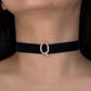 Black choker with a rose gold clasp on a person's neck