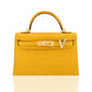Yellow crocodile skin handbag with gold hardware on a white background, collection-preview